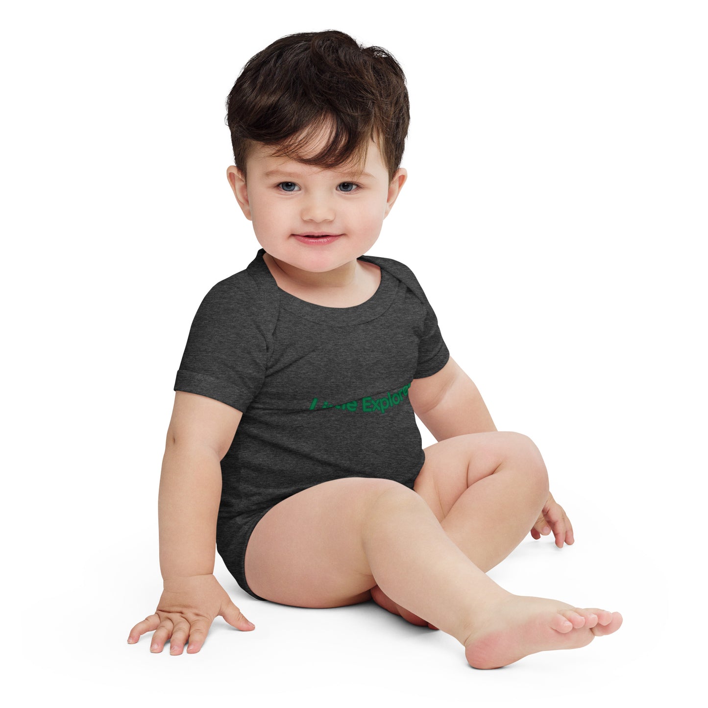 Baby wearing a dark gray onesie with green text on a white background