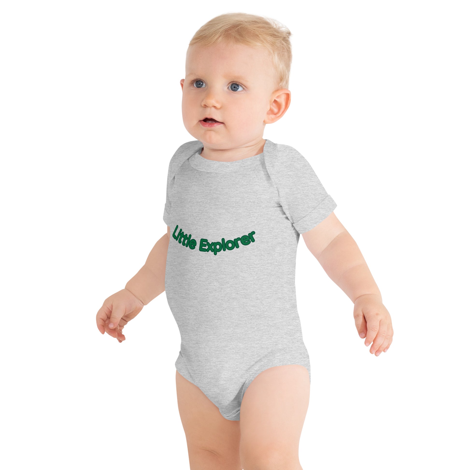 Baby wearing a gray onesie with 'Little Explorer' text on a white background