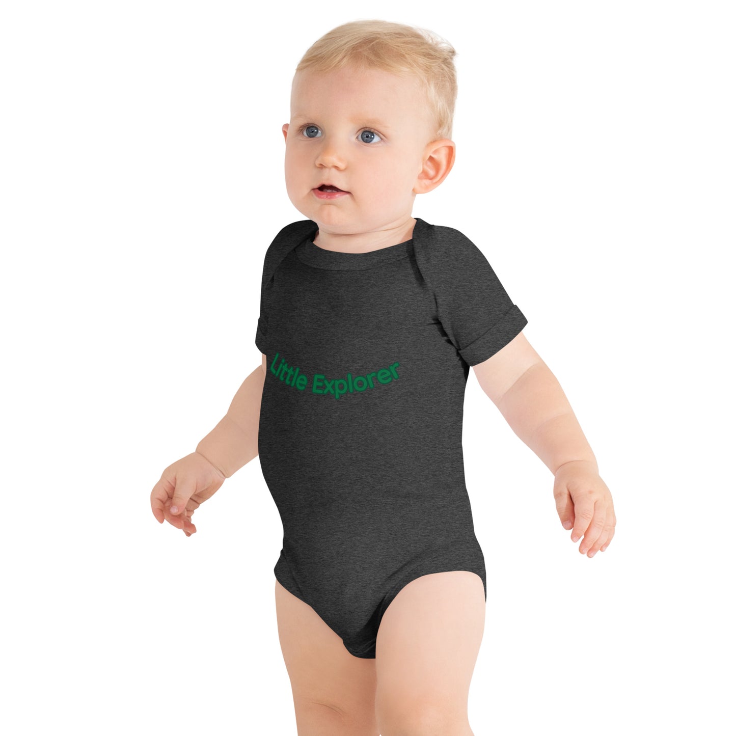 Baby wearing a dark gray onesie with 'Little Explorer' text on a white background